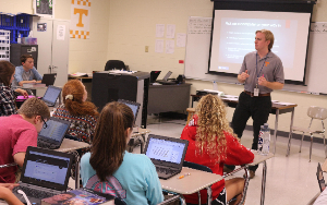 Mr. Reily reviews a lesson in English class. 